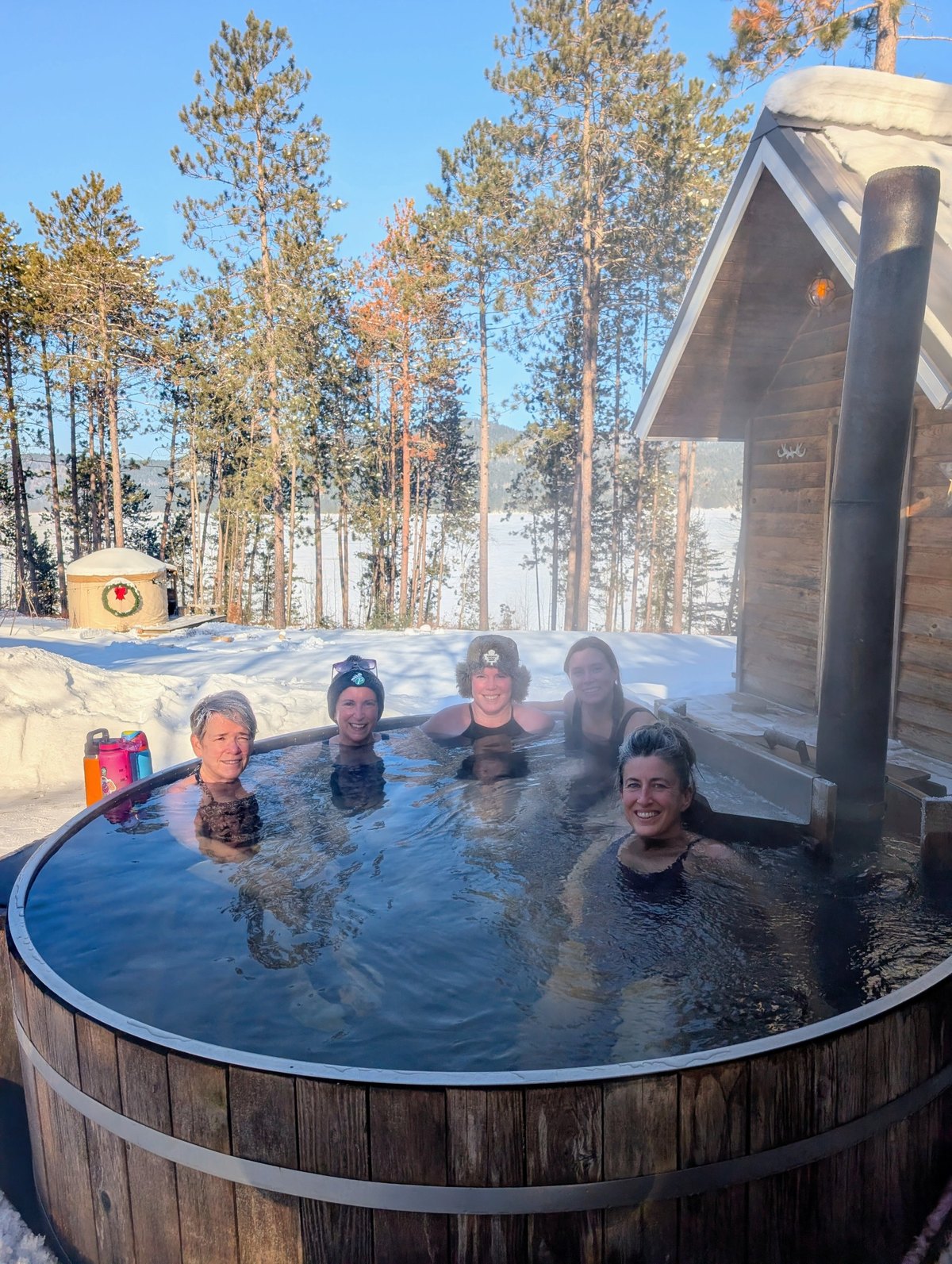 Women laughing in the hot tub in the snow